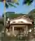 This architectural image showcases a modern tropical house with a focus on natural materials and sus