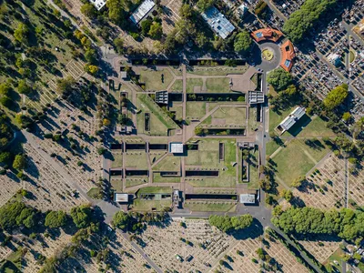This aerial photograph showcases a meticulously designed cemetery featuring a formal garden layout. 