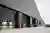 This architectural image showcases a modern industrial building with a striking black brick facade a