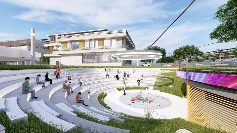 Modern amphitheater with seating, art, and surrounding greenery.