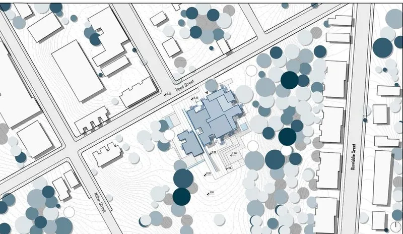 Site plan: Office building with landscaping and surrounding streets.
