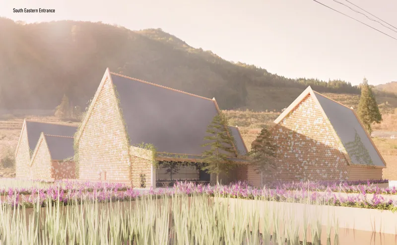 View of the gabled pavilion cluster with perforated facades across a field of purple flowers and wheat