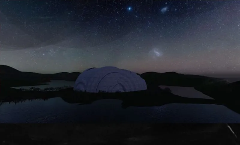 Night view of the dome structure beside water under a starry sky