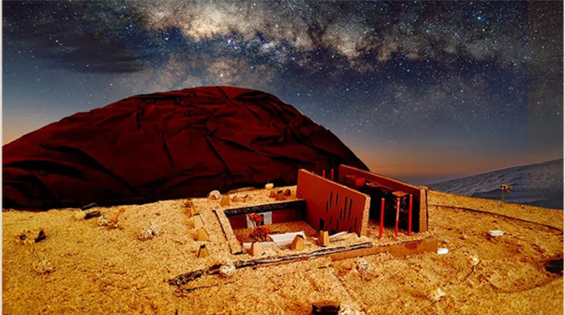 Long exposure of a model dwelling on golden sand under the Milky Way at dusk