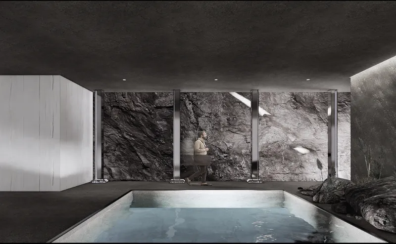Seated figure framed by steel columns against rough stone wall beside sunken water pool