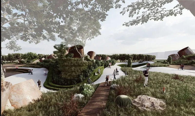 Timber boardwalk winding through landscaped mounds with native grasses and cacti beneath overhanging tree branches