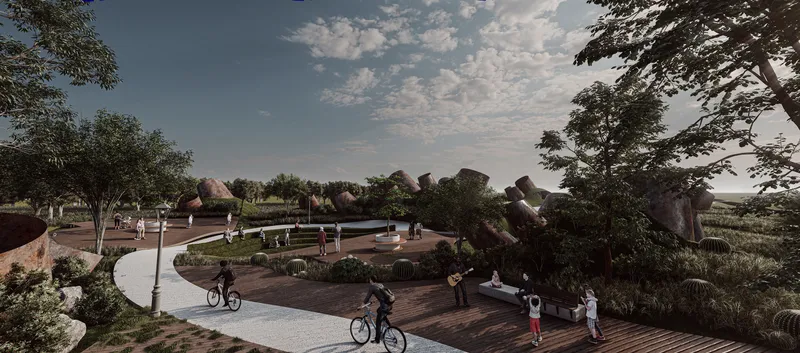 Wide view of the central plaza with paved pathways radiating from a circular gathering space at dusk