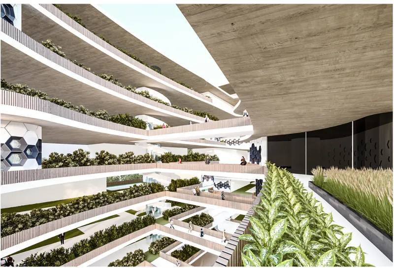 Interior atrium view looking across planted terraces beneath board-formed concrete slabs and daylight