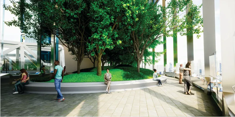 Interior courtyard with raised planter bed, mature trees, and people on seating ledges