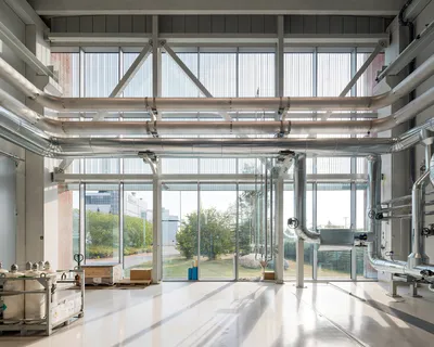 This architectural image showcases the interior of an industrial building with a focus on its functi