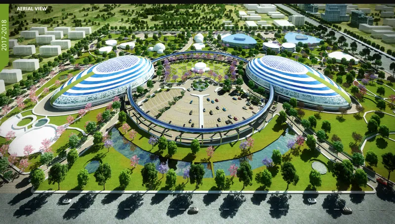 Aerial rendering of the campus showing two large blue-striped domes flanking a circular courtyard surrounded by trees and pathways