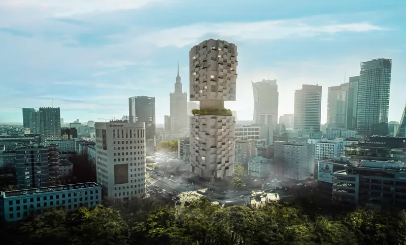 Aerial view of the stacked pixelated tower rising above surrounding buildings in morning haze