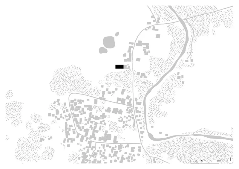 Site plan drawing showing building footprint among scattered village structures and winding river