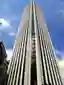 This architectural image showcases a tall skyscraper with a distinctive design. The building feature