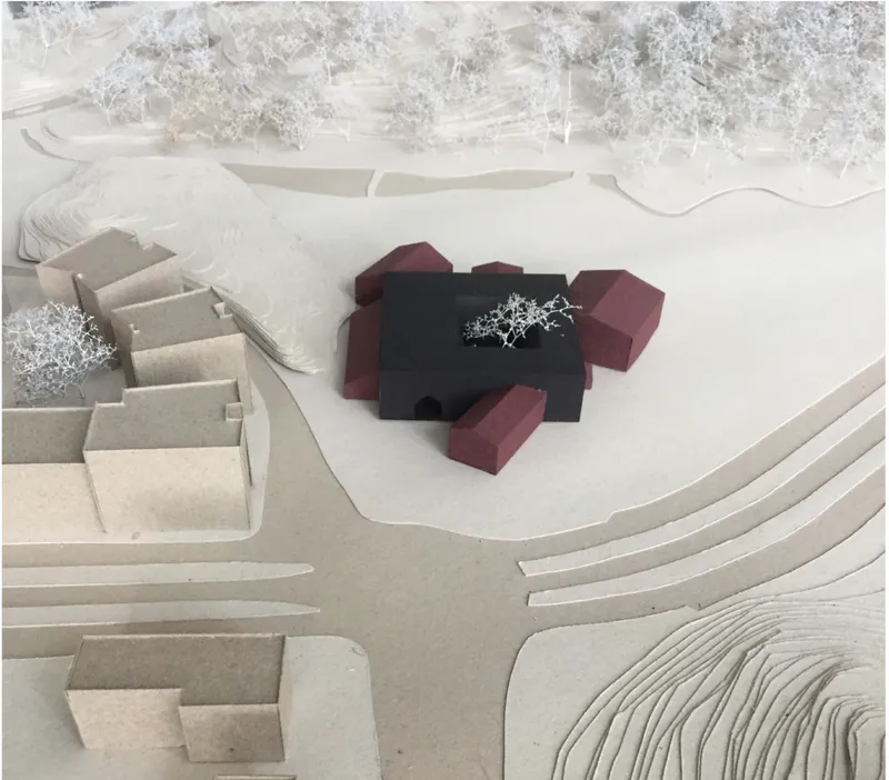 Top-down view of the physical model showing the cloverleaf-shaped volume surrounded by landscape elements
