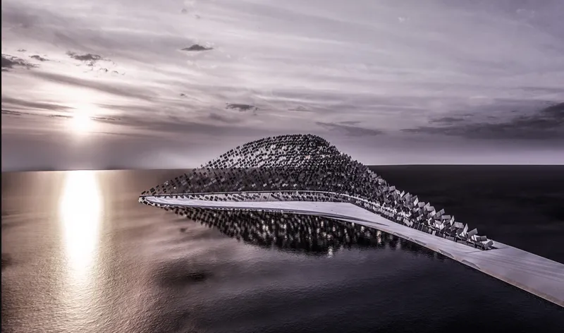 Aerial view of the arched structure extending over water at sunset with calm seas