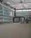 This architectural photograph showcases the interior of an industrial building, emphasizing its stru