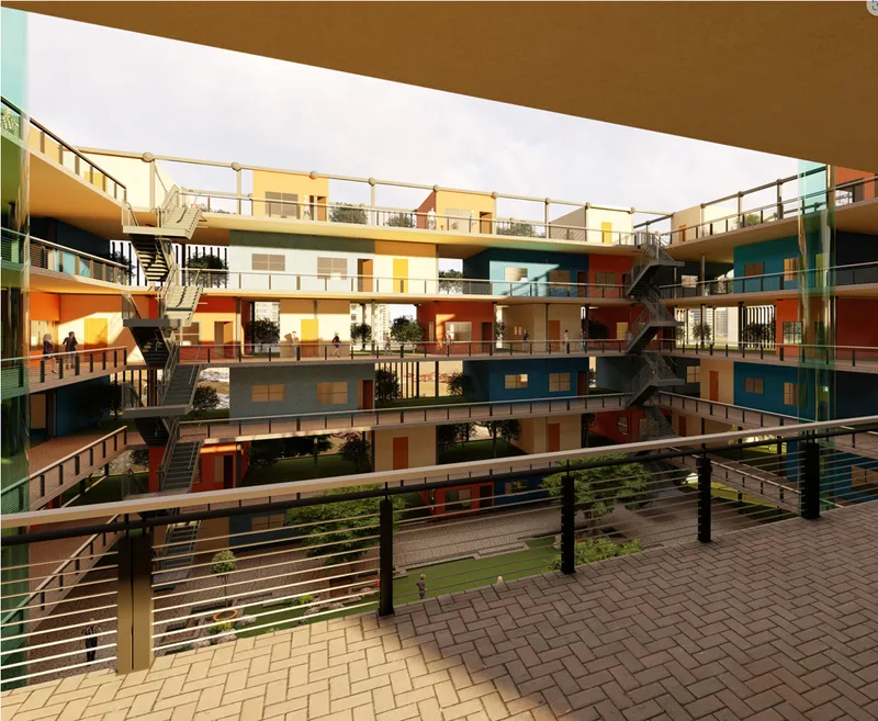 View across the internal courtyard showing multi-level stacked housing units with colored facade panels and circulation bridges