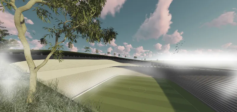 Exterior view of the curved ribbed roof wrapping around a playing field with a tree in foreground