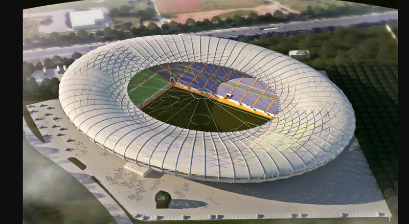 Aerial rendering of the elliptical stadium with translucent ribbed roof and central pitch surrounded by parking areas