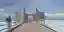 This architectural image showcases a modern pier structure with minimalist design elements. The pier