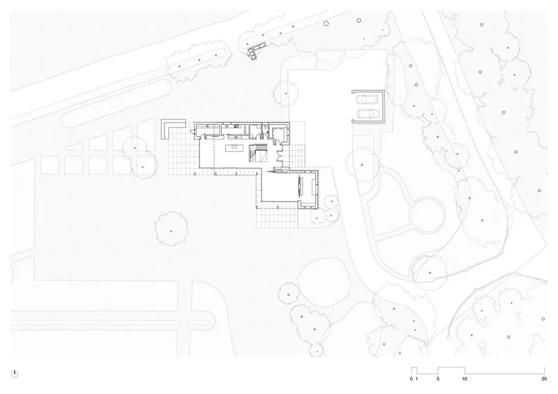 Site plan drawing showing house and garage positioned among existing trees and landscape contours