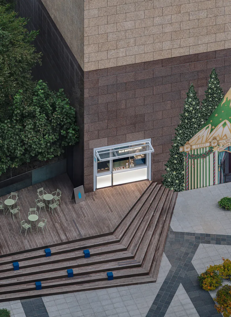 Aerial view of timber deck terraces with blue cube accents beside outdoor seating area