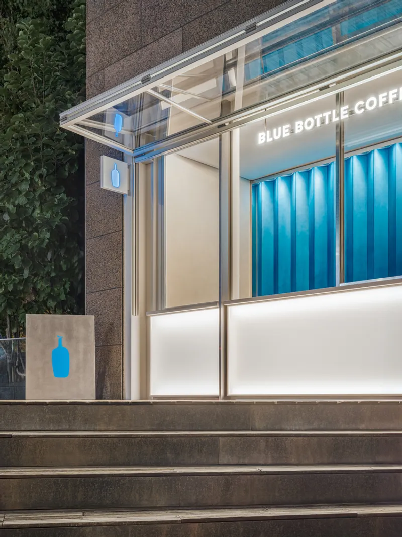 Close-up of glazed canopy and aluminum frame above illuminated counter base