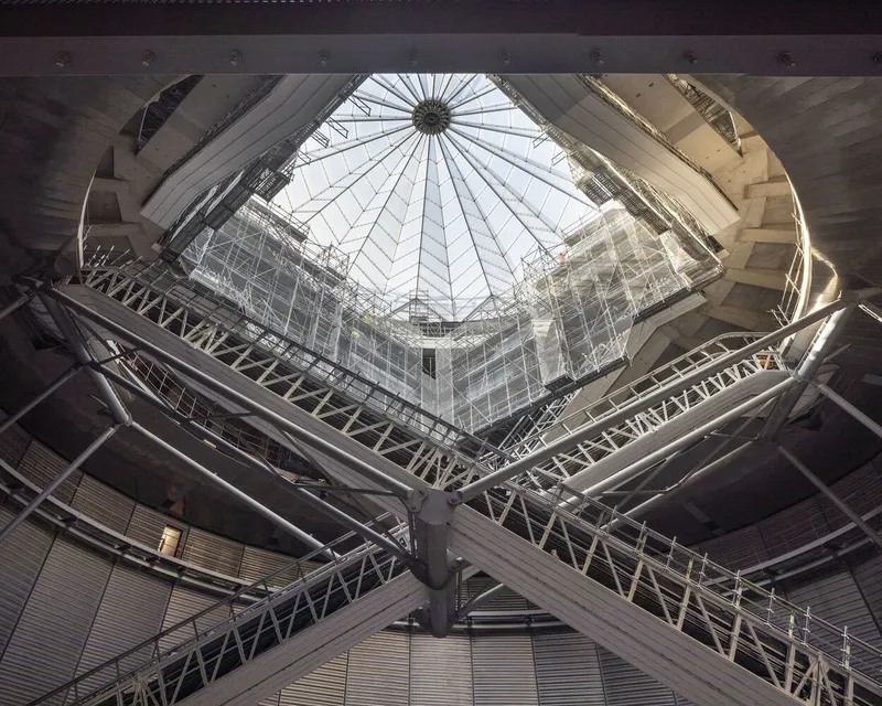 Looking up through the central atrium with radiating cable structure and glazed dome overhead