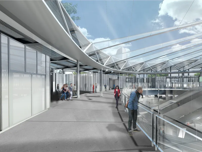 Platform-level concourse with passengers walking beneath exposed steel trusses and a transparent roof canopy