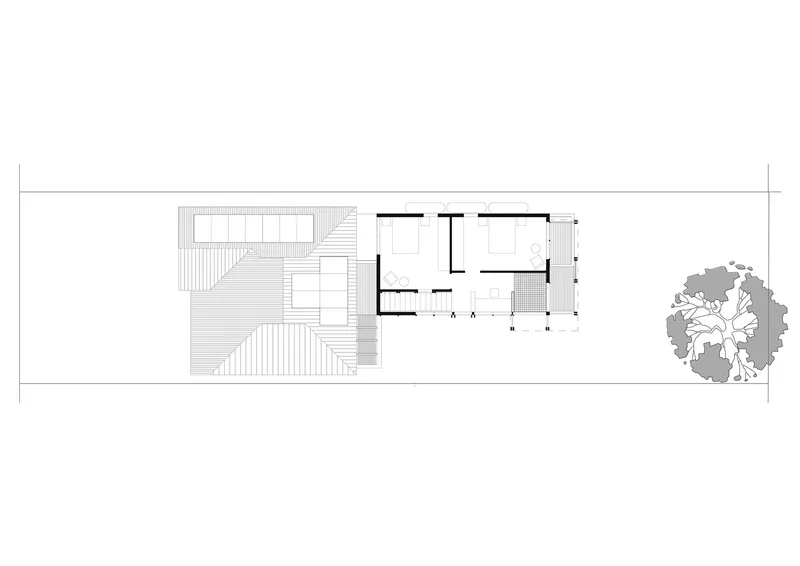 Upper floor plan drawing showing interior rooms with a deck and adjacent tree
