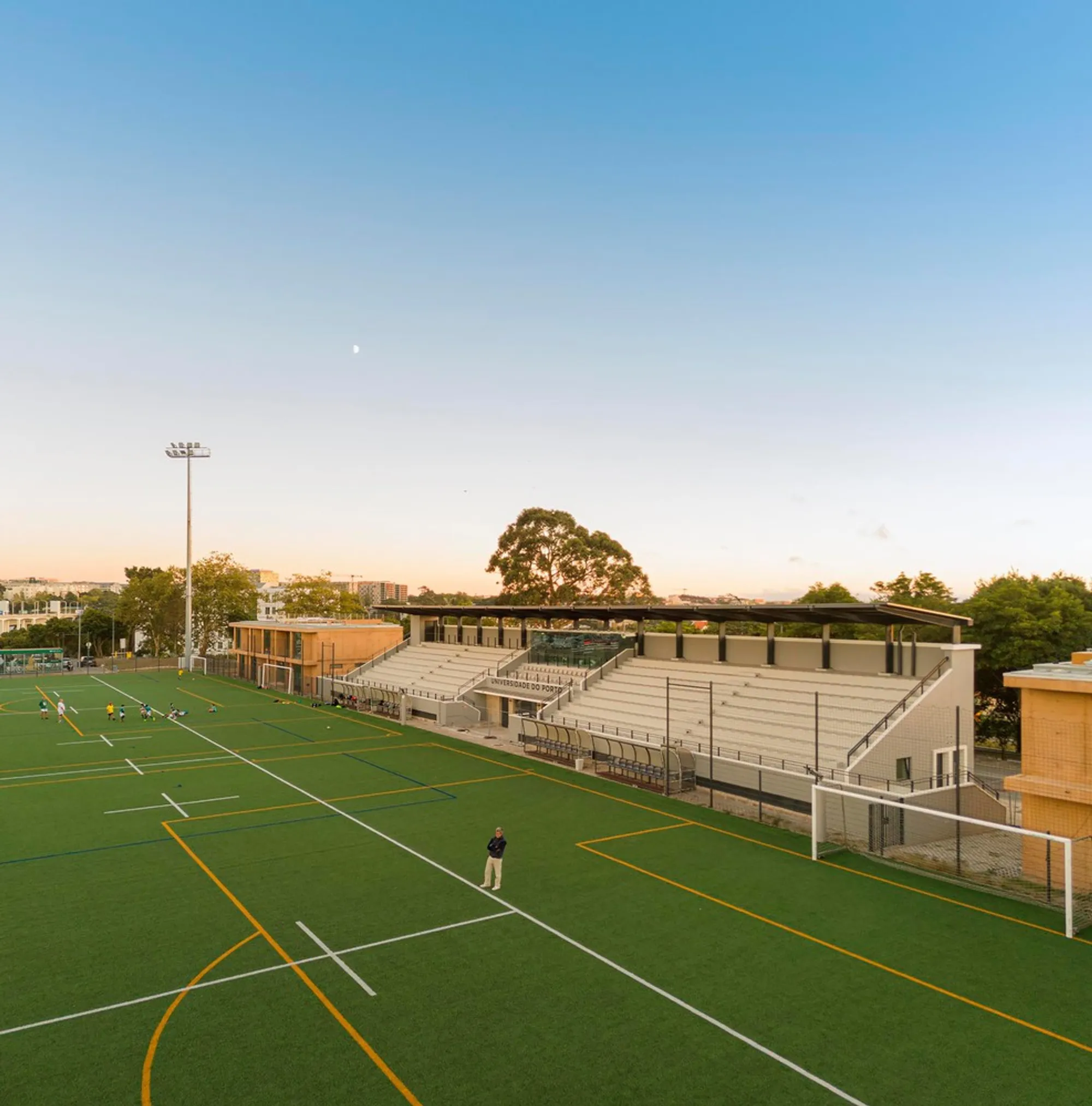 Crea Arquitetos Extends a 1953 University Stadium in Porto with Terracotta Concrete Pavilions