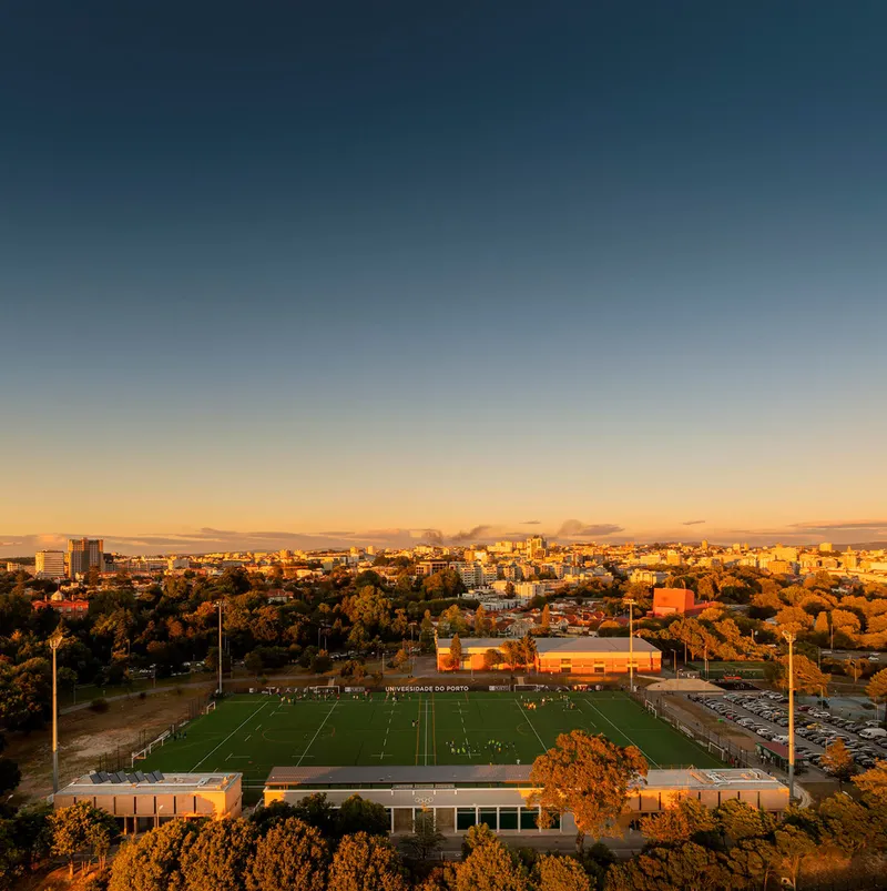 Aerial view of the sports complex and playing fields at sunset with trees in autumn foliage