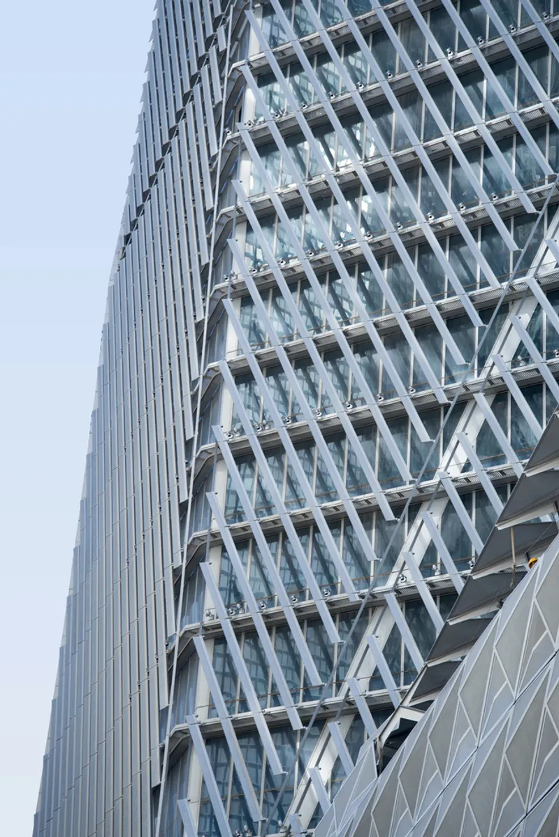 Close-up of the diagonal white exoskeleton bracing system wrapping the glass curtain wall