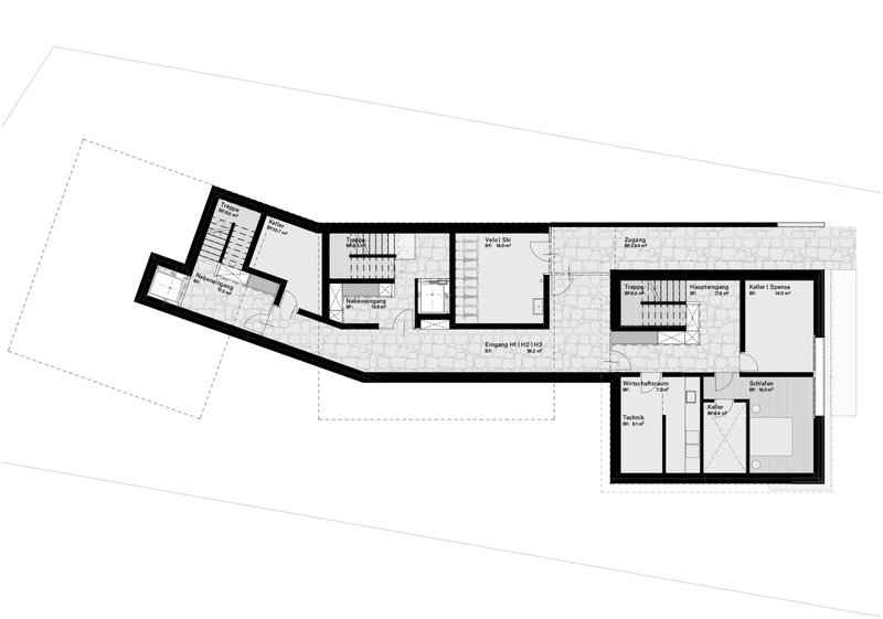 Floor plan drawing showing an elongated residential layout with central staircase and angled wing