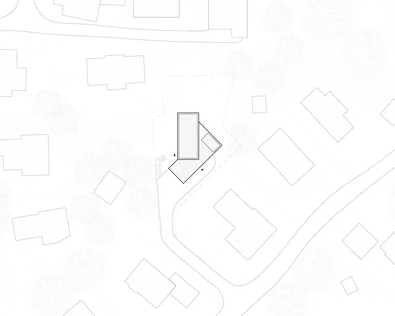 Site plan drawing showing the building footprint positioned among neighboring structures and winding access road