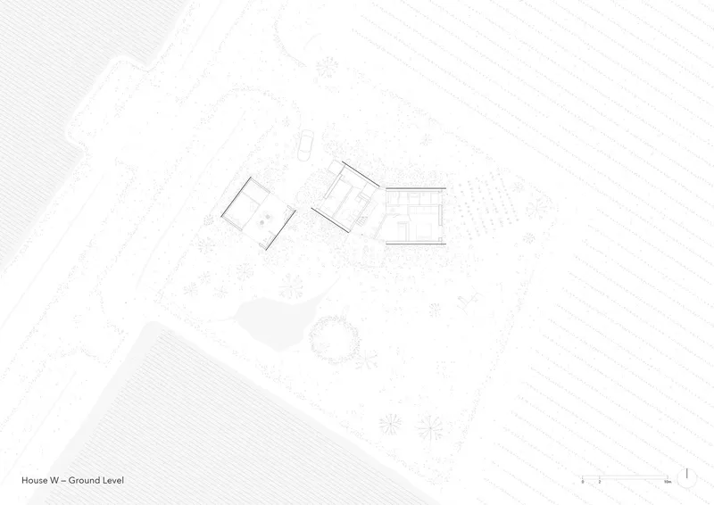 Ground level floor plan showing three angled volumes arranged around a central courtyard with surrounding landscape