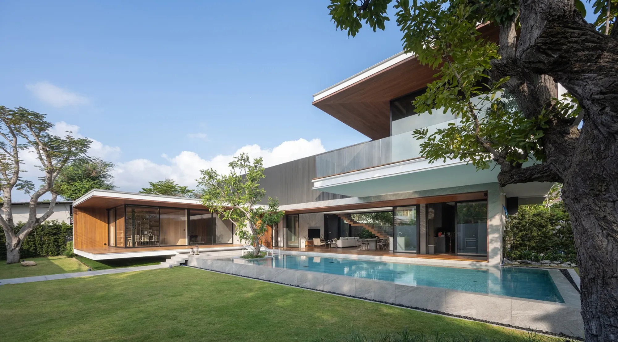 WARchitect Cantilevers a Teak-Clad Bedroom Six Meters Over a Bangkok Swimming Pool