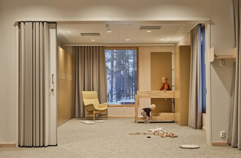 Interior room with folding fabric partition, built-in bunk bed, and window overlooking a snowy forest