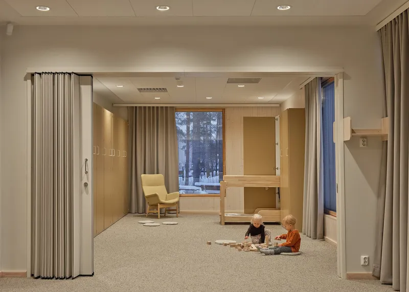 Same room with two children playing on the carpet beneath the timber bunk bed