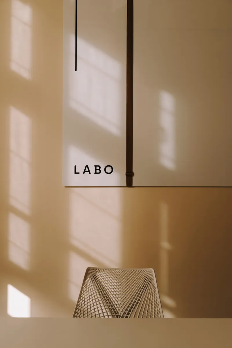 Display window with woven basket on shelf and soft shadows from afternoon sun