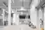 This architectural image showcases the interior of a modern warehouse, characterized by its spacious