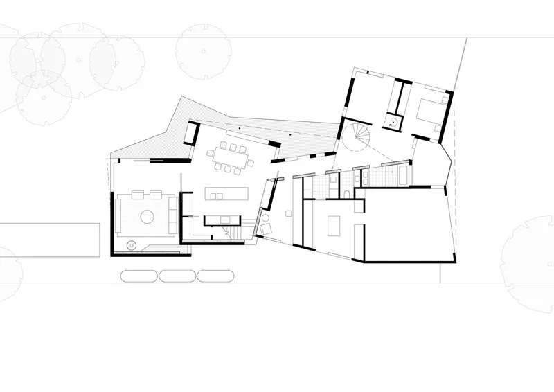 Ground floor plan drawing showing angular living spaces and central kitchen with outdoor terrace
