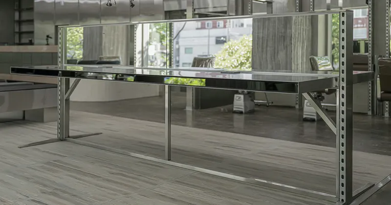 Low view of mirrored platform framed by galvanized steel uprights with salon chairs visible in background