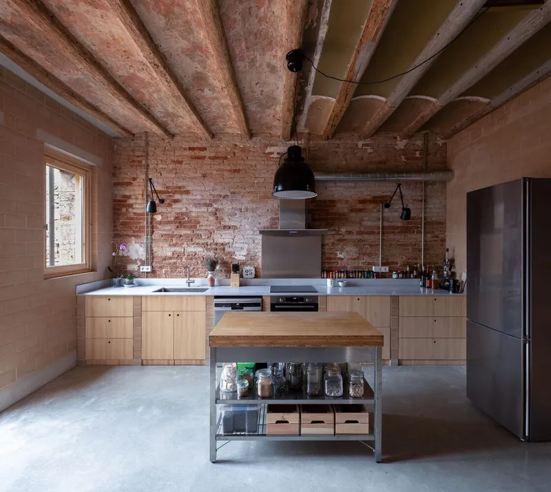 Kitchen with timber cabinetry and exposed wooden ceiling beams above a central island with shelving
