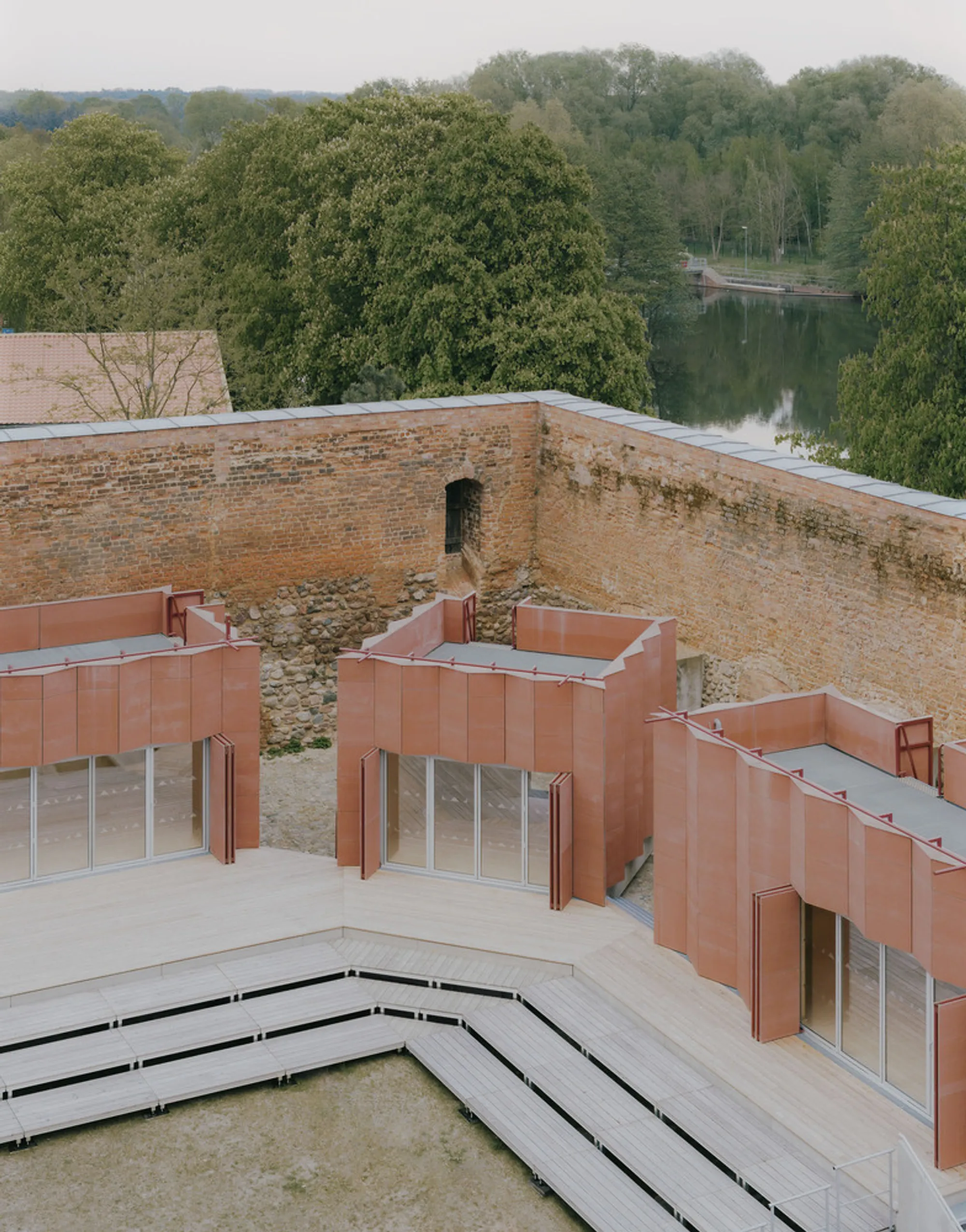 Atelier Fanelsa Nests Three Copper Pavilions Inside a Medieval Castle Courtyard in Beeskow