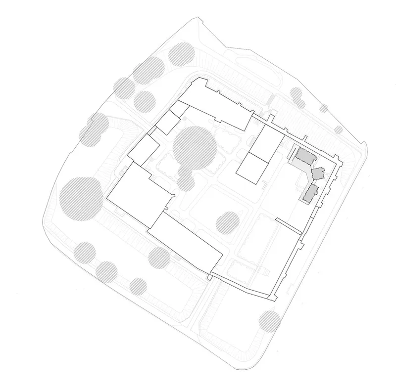 Site plan drawing showing rectangular building volumes within a rounded boundary with surrounding trees