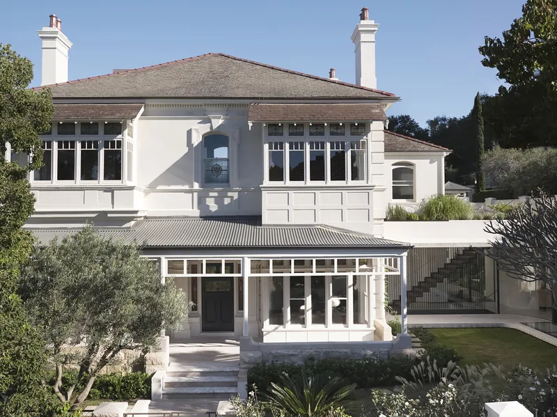 Garden facade showing the heritage upper level with hipped roof and the lower glass pavilion addition