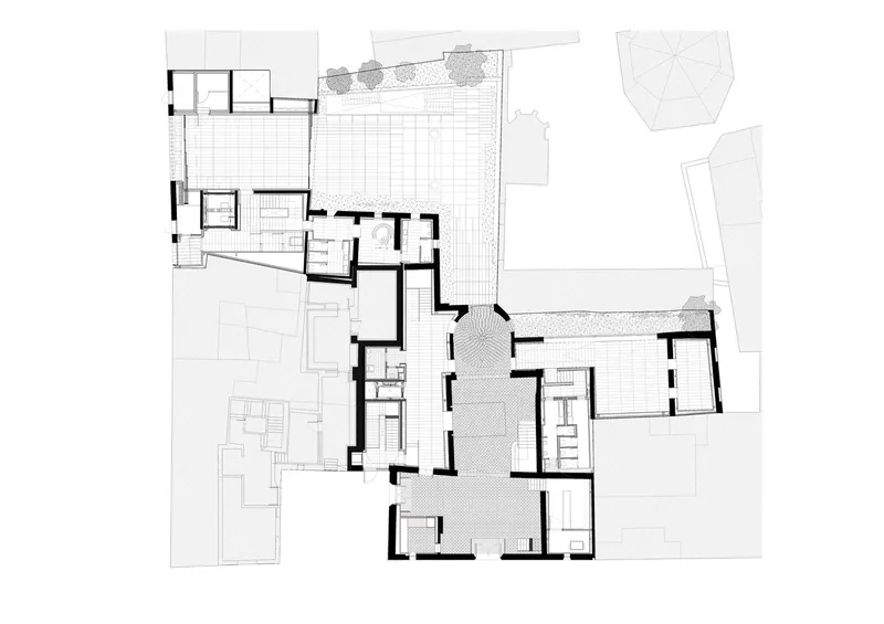 Floor plan showing an L-shaped layout with central courtyard and pool deck flanked by interior rooms