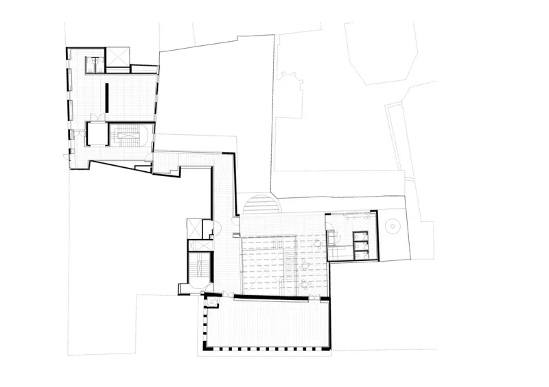 Floor plan showing two wings connected by a bridge with exterior steps descending the sloped site